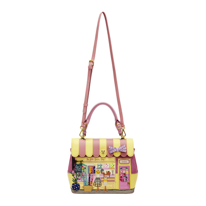 Handbag with a store design and pink strap on a white background