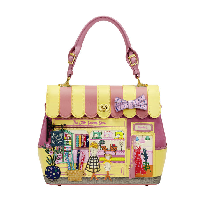 Handbag designed like a store front with a pink and yellow color scheme on a white background