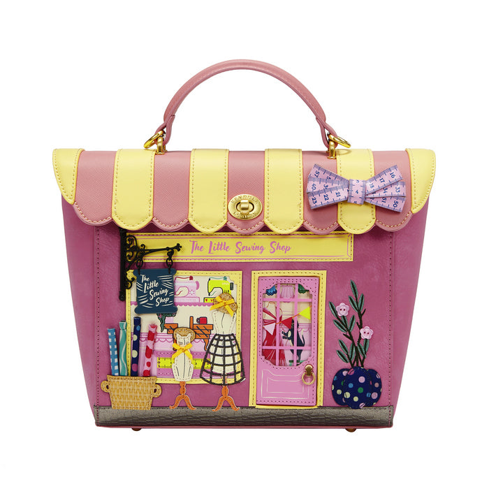 Pink and yellow handbag with 'The Little Sewing Shop' design on a white background