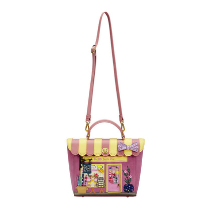 Pink handbag with yellow accents and a bow detail on a white background