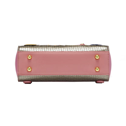 Pink handbag with gold accents on a white background