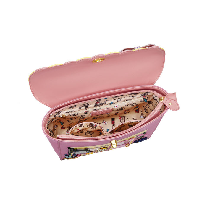 Pink handbag with open front revealing a patterned interior on a white background
