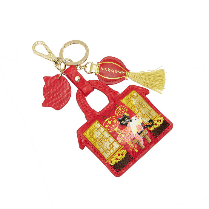 Red keychain with decorative design on a white background