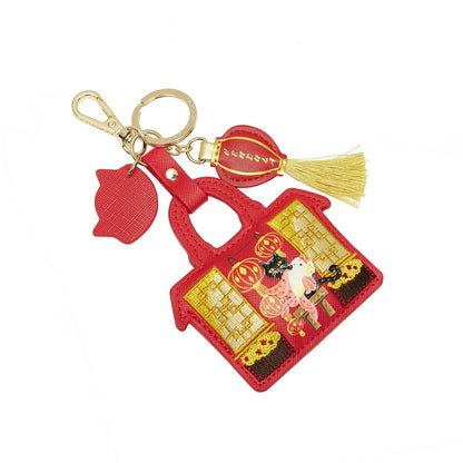 Red keychain with decorative design on a white background
