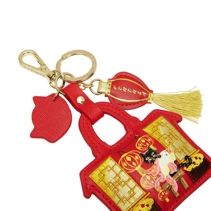 Red lantern keychain with gold accents on a white background