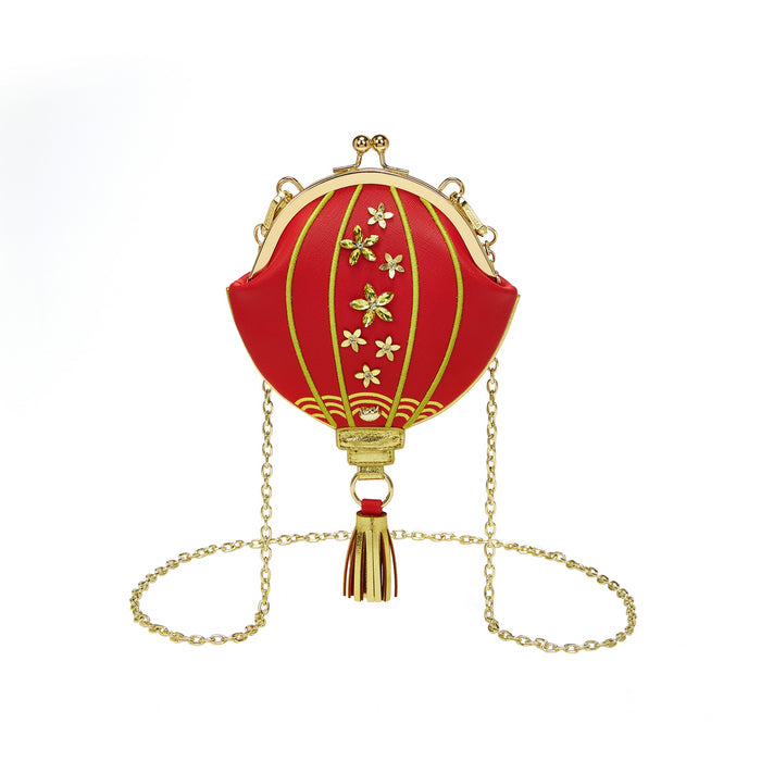Red lantern-shaped pendant with gold chain on a white background
