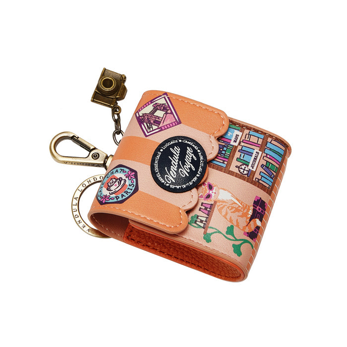 Small wallet with keychain and patches on a white background