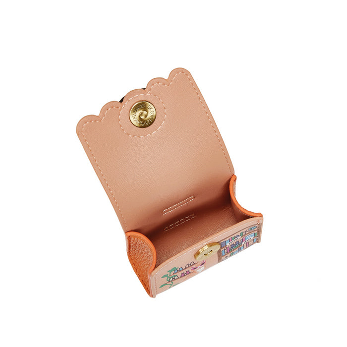 Small pink leather wallet with colorful interior on a white background