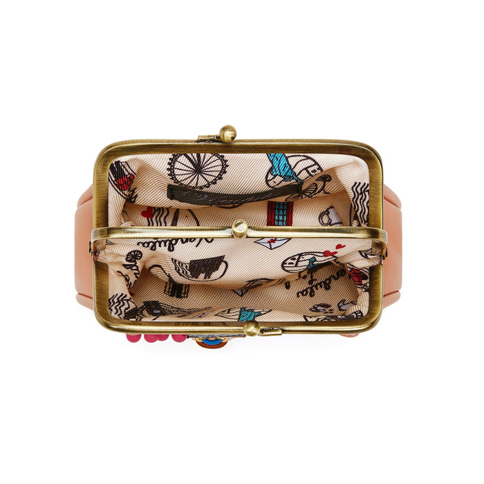 Pink clutch bag with gold clasp and patterned interior on a white background