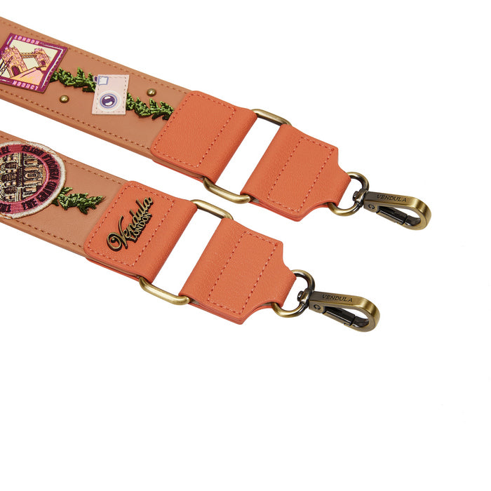 Peach-colored leather strap with gold hardware and decorative elements on a white background