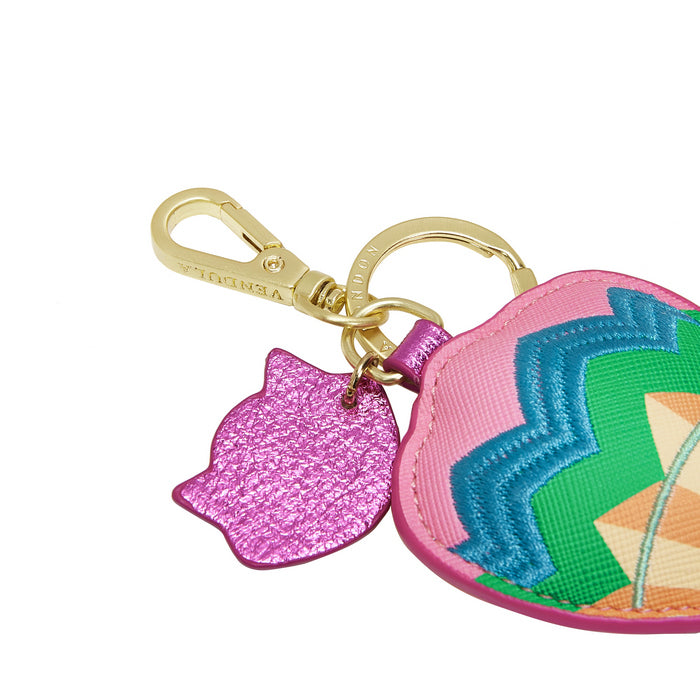 Colorful keychain with geometric design and pink cat-shaped charm on a white background