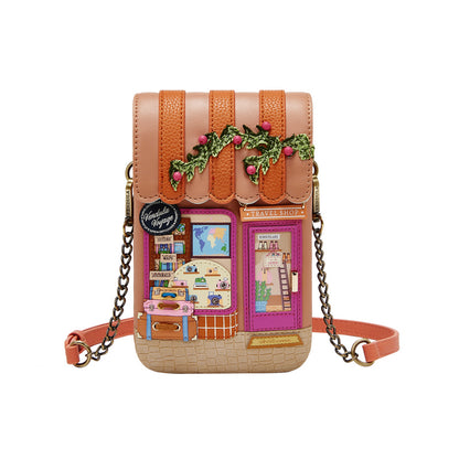 House-shaped crossbody bag with decorative elements on a white background