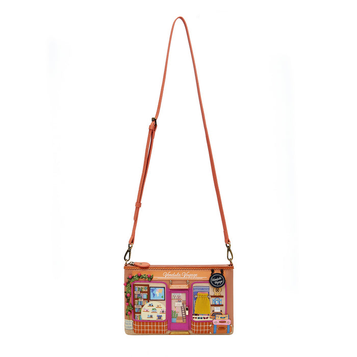 Crossbody bag with a colorful design of a store front on a white background