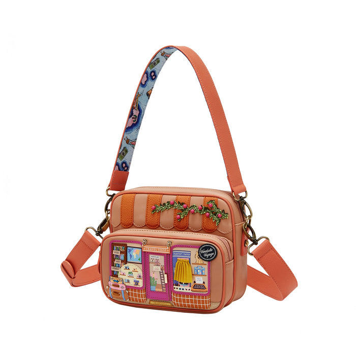Orange crossbody bag with fabric patch design on a white background