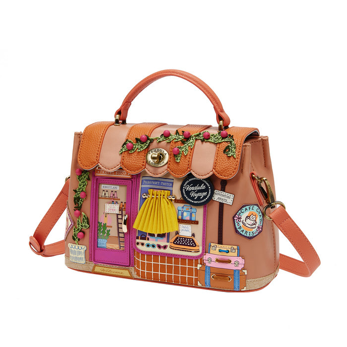 Decorative handbag with colorful patches and a handle on a white background