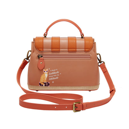 Brown handbag with orange strap on a white background
