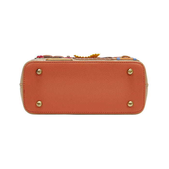 Orange handbag with decorative elements on a white background