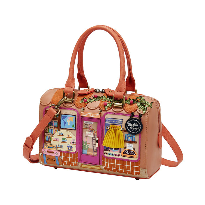 Pink handbag with decorative panels on a white background