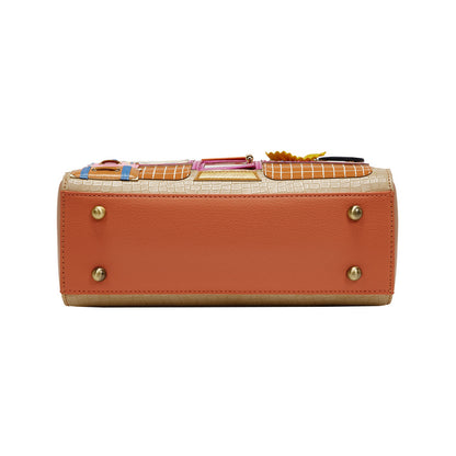 Orange handbag with gold accents on a white background