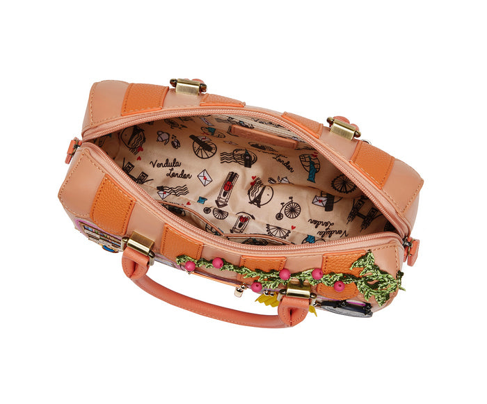 Pink handbag with decorative handle on a white background