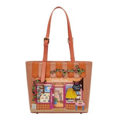 Tan tote bag with colorful design of a store front on a white background