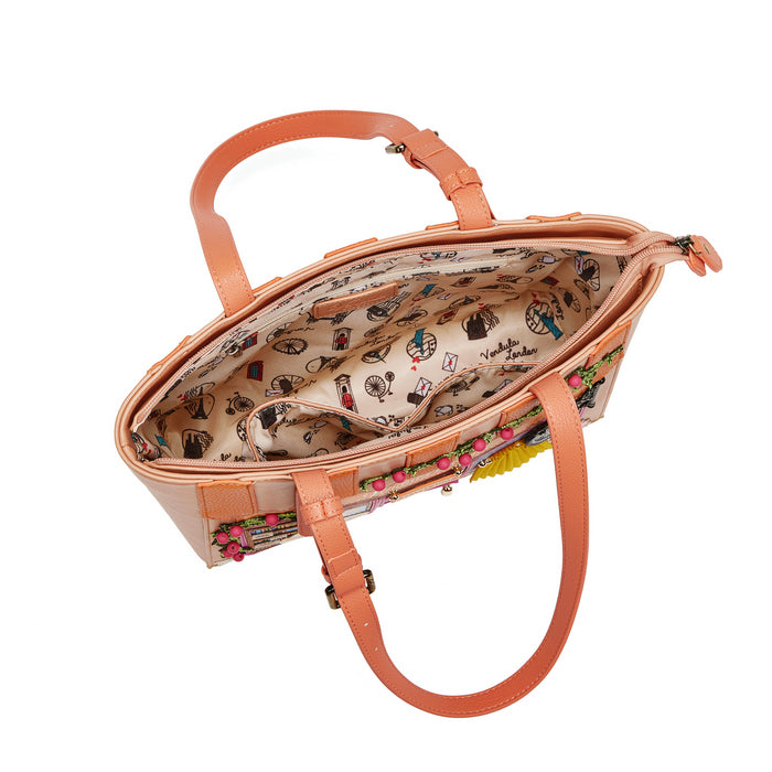 Peach-colored handbag with floral pattern on a white background