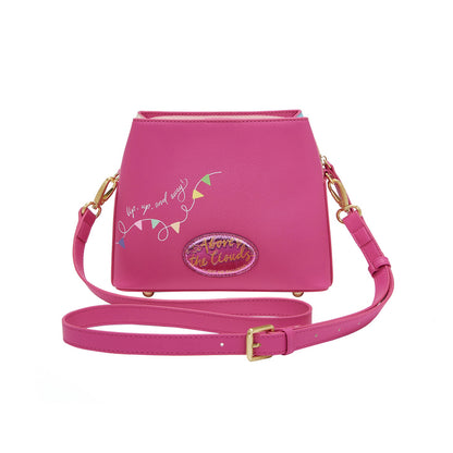 Pink handbag with decorative text and design on a white background