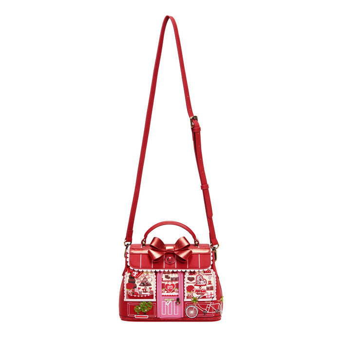 Red handbag with a decorative bow on a white background