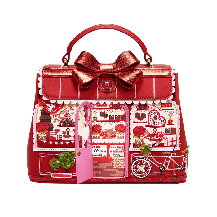 Red handbag with decorative bow and festive design on a white background