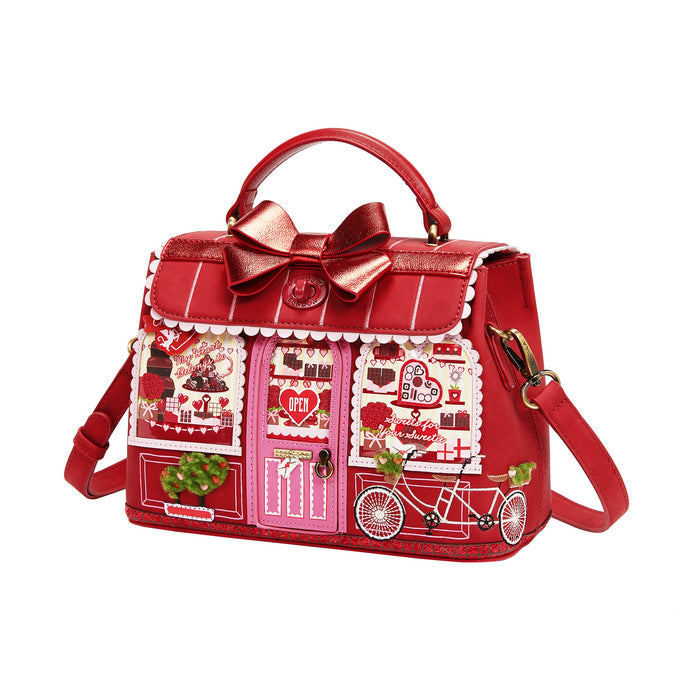 Red handbag with decorative elements on a white background