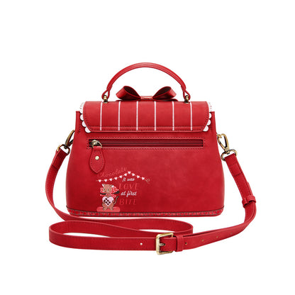 Red handbag with decorative elements on a white background