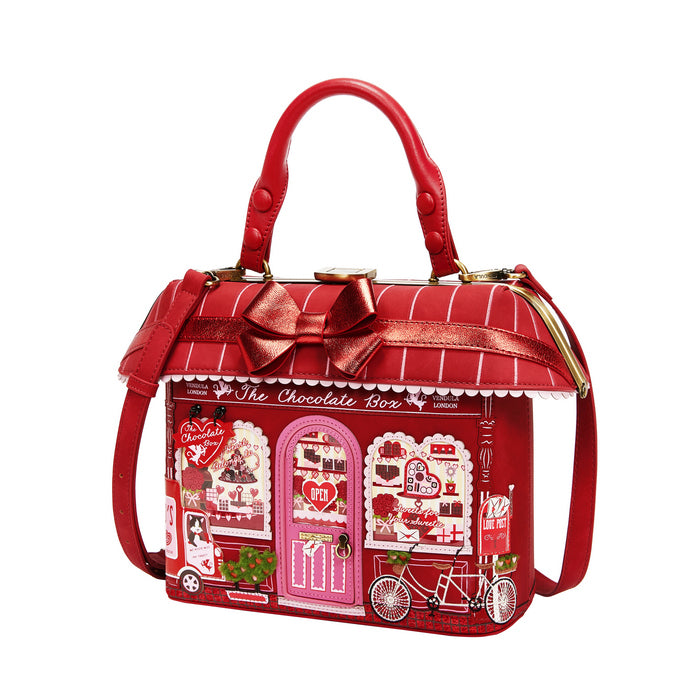 Red handbag designed like a chocolate box with a bow on a white background