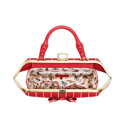 Red handbag with gold accents and a patterned interior on a white background