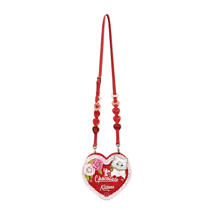 Heart-shaped keychain with floral design and red strap on a white background