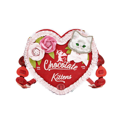 Heart-shaped chocolate container with a cat design and 'Chocolate Kittens' text on a white background