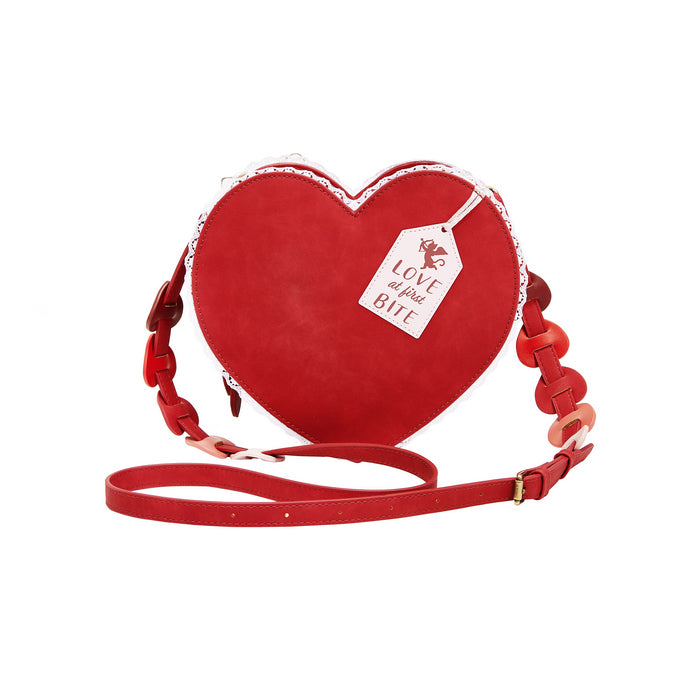 Red heart-shaped bag with a tag on a white background
