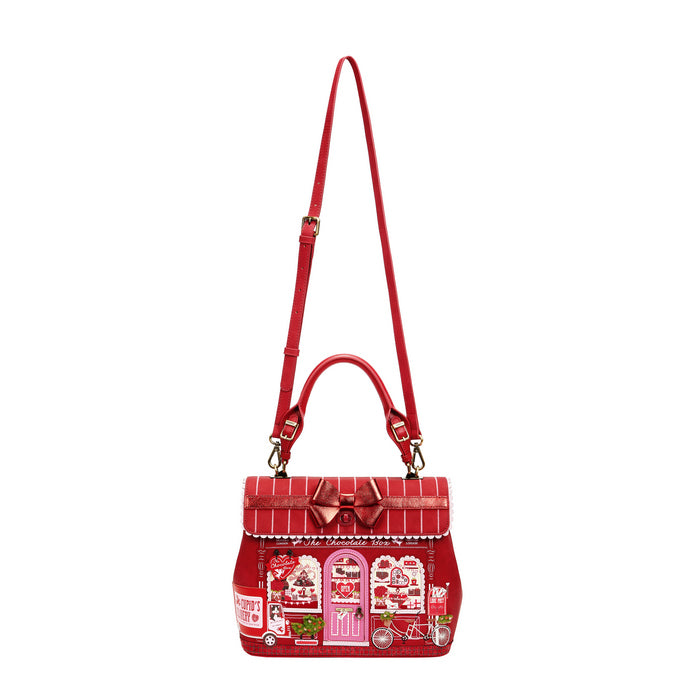 Red handbag with a detailed design on a white background