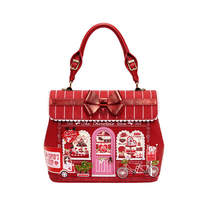 Red handbag with a decorative bow and Valentine's Day-themed design on a white background