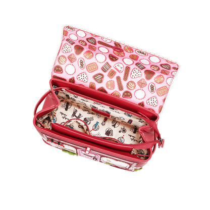 Pink and red handbag with a patterned interior on a white background