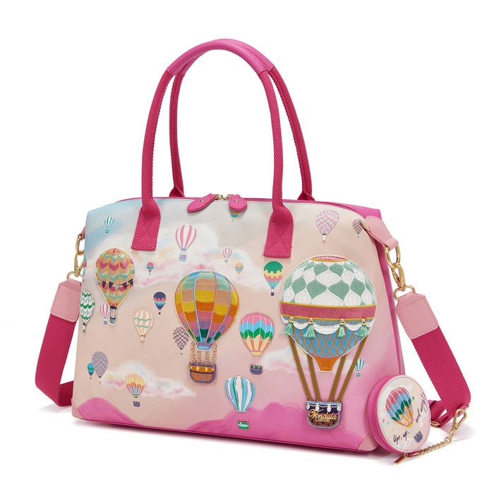 Pink handbag with hot air balloon design on a white background