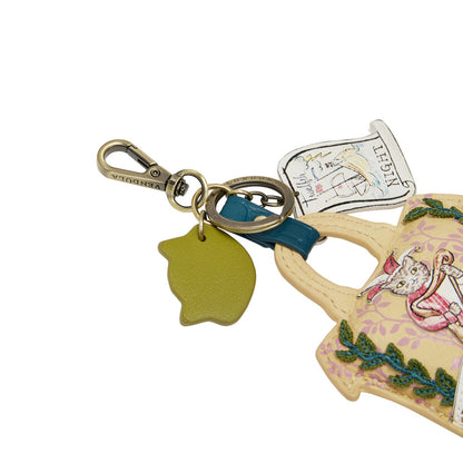 Decorative keychain with a teapot design and cartoon character on a white background