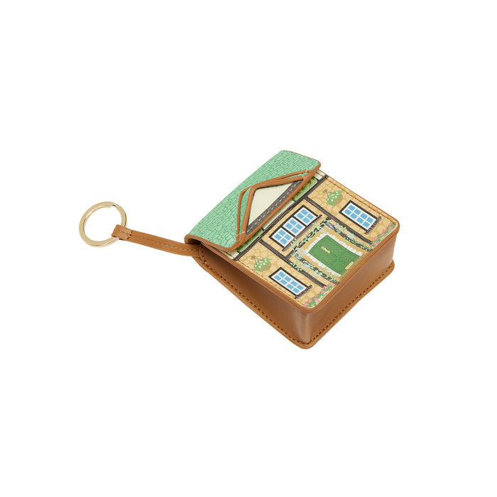 Small house-shaped keychain with a green roof and brown base on a white background