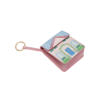 Pink keychain with a cartoon design on a white background