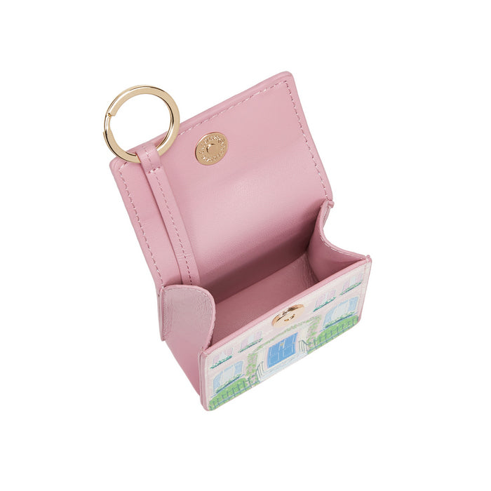 Pink keychain case with a scenic design on a white background