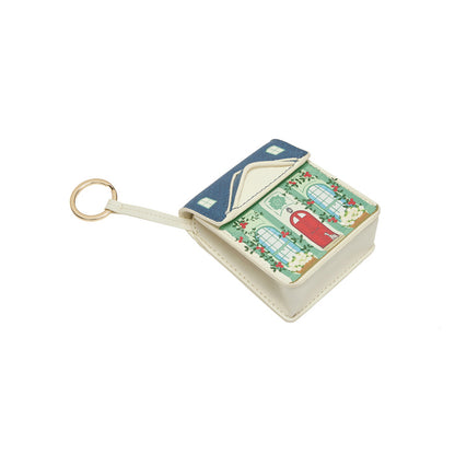 Small book-shaped keychain with a colorful design on a white background