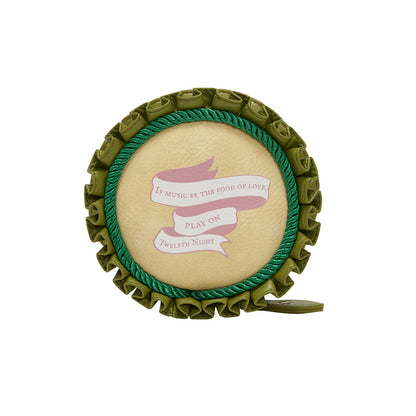 Circular decorative item with green border and text on a white background