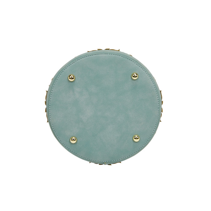 Round light blue cushion with gold buttons on a white background