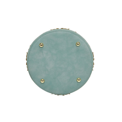 Round light blue cushion with gold buttons on a white background