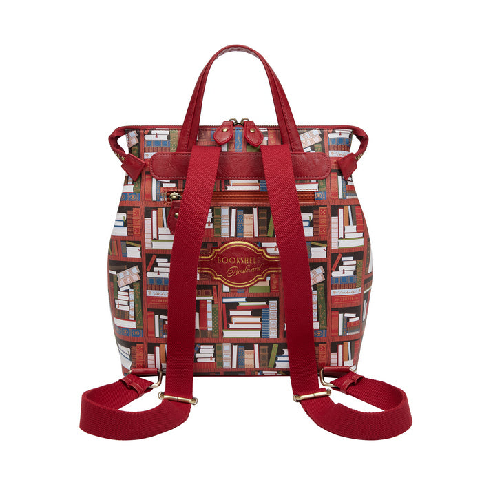 Backpack with book-themed pattern and red straps on a white background