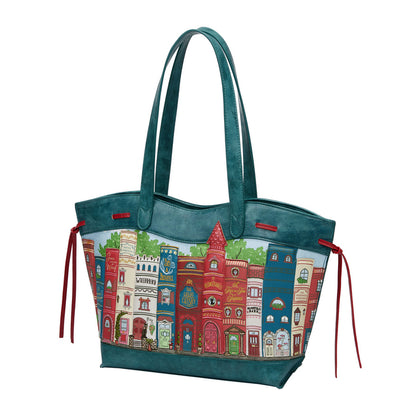 Teal handbag with colorful cityscape design on a white background
